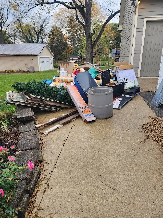 Dumpster being loaded with debris for Commercial Dumpster Rental in Fuquay